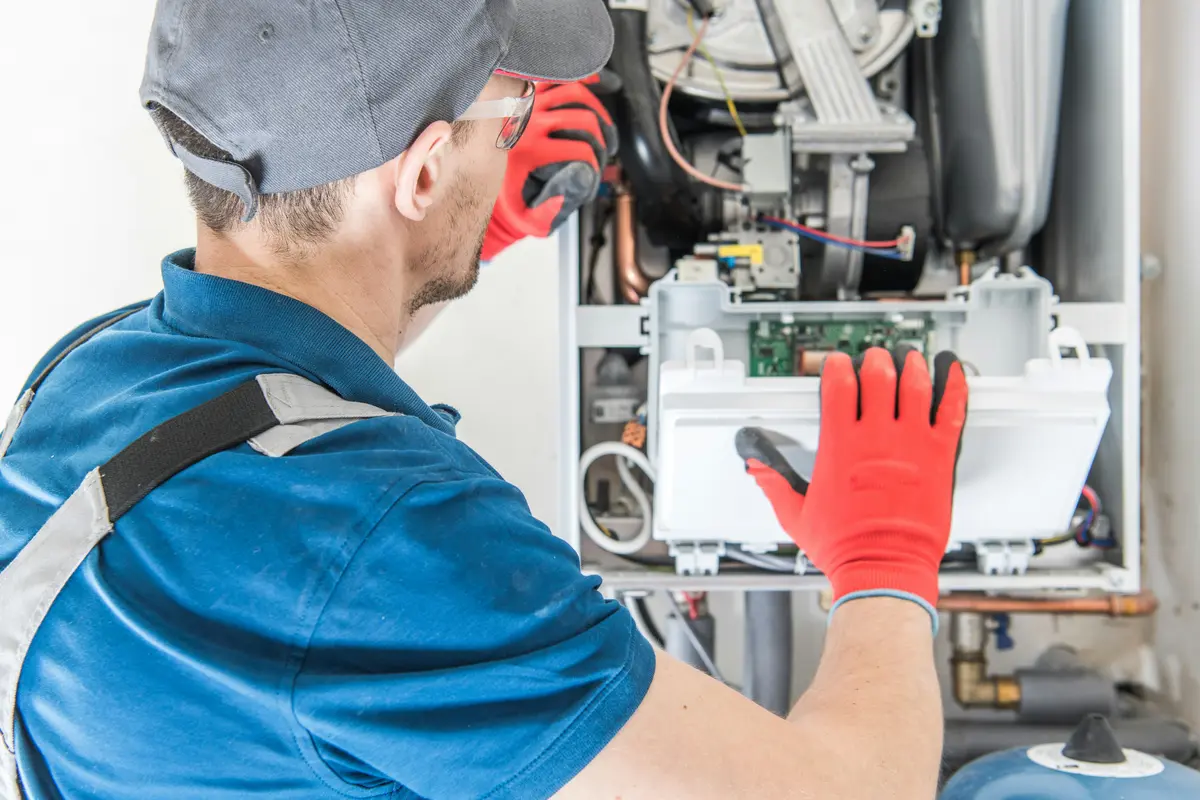 HVAC technician performing annual maintenance on a boiler in Edmonton