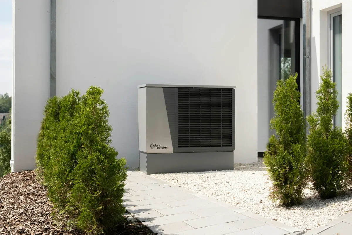 Cold-climate heat pump outdoor unit mounted on Edmonton home exterior