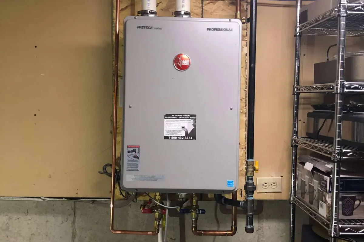 Rheem tankless water heater installed on a wall in a Edmonton basement